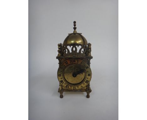 A Smiths brass cased reproduction electric lantern timepiece, 18cm high, a pair of French plated binoculars with leather cove