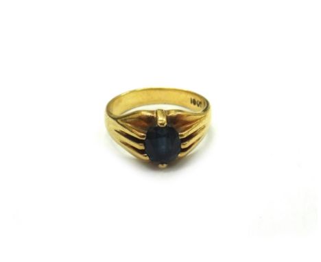 An early 20th century gold and oval mixed-cut sapphire gypsy ring, stamped 18ct, ring size K, 6.4gms gross.