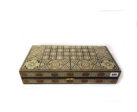 A Damascus ware folding backgammon games board, inlaid with different coloured woods and bones, 40 x 40cm, dice shaker and co