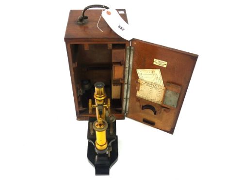 E. Leitz Wetzlar 51629:  A brass and Japanned single pillar microscope, circa 1900, with lenses, objectives and slides in a f