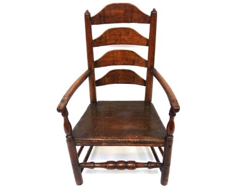 An ash ladder back elbow chair, second half 18th century, with solid seat, on rounded legs united by stretchers.