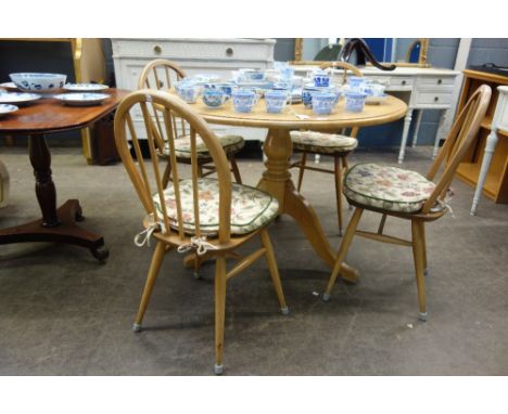 A reproduction George III style light oak breakfast table, the circular top on a baluster turned pillar and tripod base, 107c