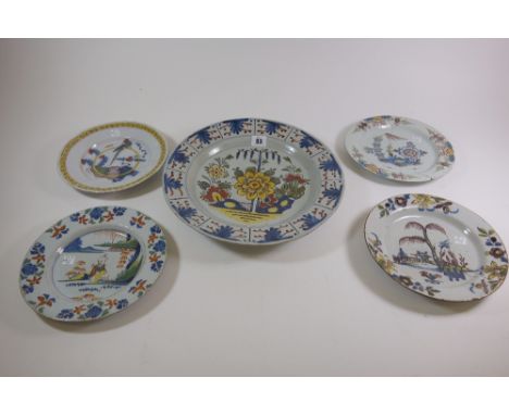 A Lambeth polychrome delftware plate, circa 1750, painted in the centre with an oriental seated on a rocky promantory inside 