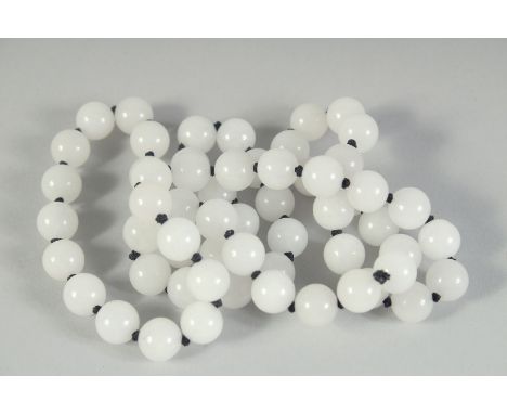 A STRING OF WHITE JADE BEADS. 30ins long.