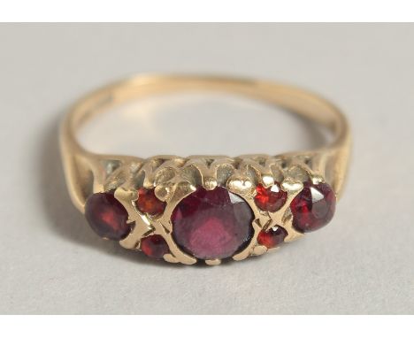 AN EDWARDIAN GOLD FIVE STONE RUBY RING.