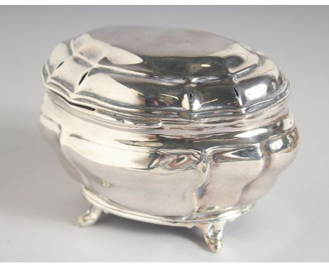 AN EDWARD VII BOMBE SHAPED SILVER TEA CADDY AND COVER. 4.75ins long, 3.5ins deep, supported on four curving legs. London 1901