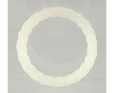 A WHITE JADE TWIST BANGLE.