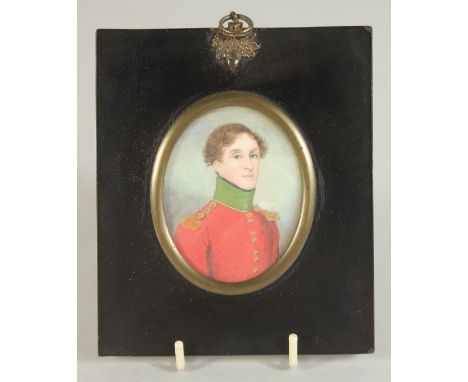 19TH CENTURY IRISH SCHOOL. PORTRAIT MINIATURE OF A YOUNG MAN in a red uniform coat. 3ins x 2.25ins framed.