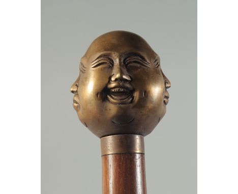 A WOODEN WALKING STICK with brass FOUR FACES HANDLE.