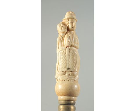 A CARVED BONE HANDLED WALKING STICK "EROTIC".