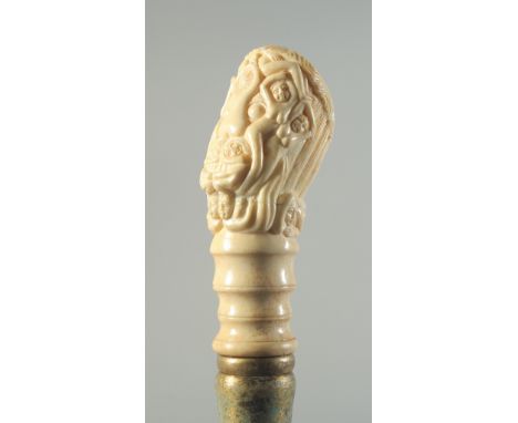 A CARVED BONE HANDLED WALKING STICK "EROTIC".