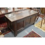AN 18TH CENTURY OAK COFFER with plank top, triple panel front with panelled ends. 4ft 8ins long x