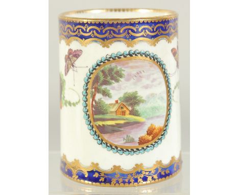 A GOOD WORCESTER PORCELAIN TANKARD, blue and gilt borders, painted with fruit, butterflies and a lake scene. Crescent mark in