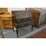 AN 18TH CENTURY BUREAU ON STAND, later carved, with a drop flap, two small drawers and two drawers