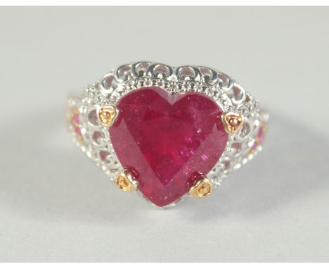 A SILVER AND RUBY HEART RING.