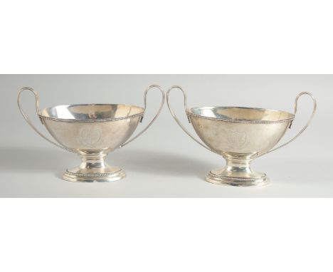 A GOOD PAIR OF GEORGE III SILVER OVAL TWO HANDLED SAUCE TUREENS with bead edge. London 1784. Maker: B. M. Weight: 24ozs.