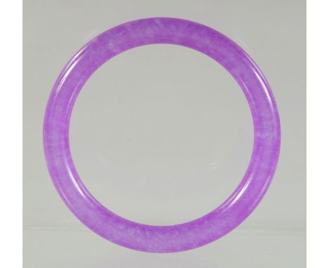 A LAVENDER JADE BANGLE. 7.5ins diameter.