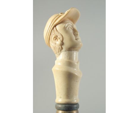 A CARVED BONE HANDLED WALKING STICK "MAN'S HEAD WITH CAP".
