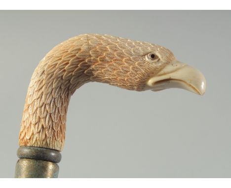 A CARVED BONE HANDLED WALKING STICK "EAGLE".