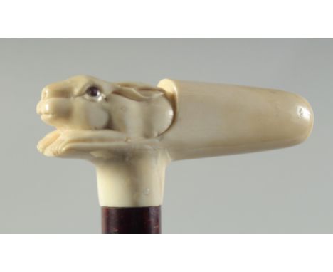 A CARVED BONE HANDLED WALKING STICK "RABBIT".