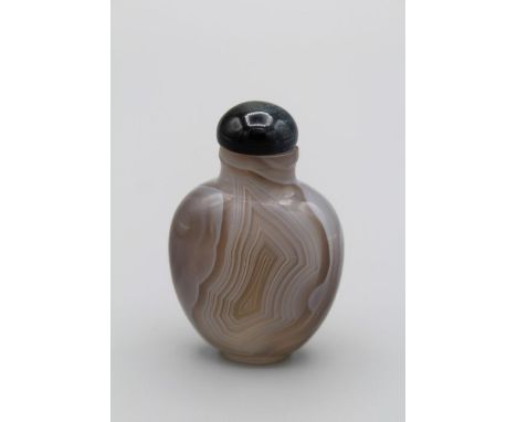 Chinese snuff bottle.Fine thumb print agate of compressed ovoid form supported on a small raised oval foot, with slightly fla