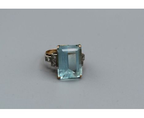 An Art Deco Aquamarine and diamond cocktail ring, in unmarked yellow gold mount. Central stone measures approximately 17mm x 