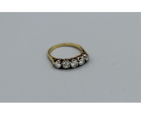 A five stone diamond half hoop ring, estimated 1ct total diamond weight in unmarked yellow metal, size N, approximately 3.4gm