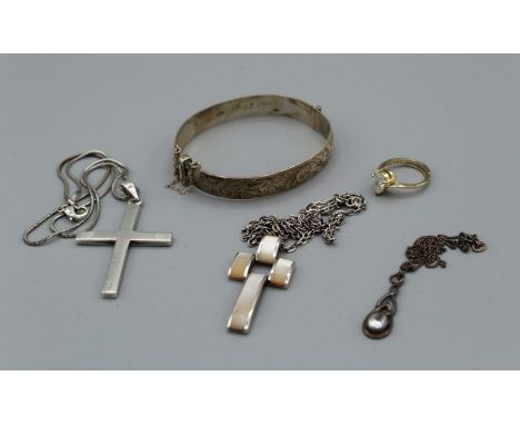 A selection of silver jewellery comprising a hallmarked and engraved hinged bangle, a hallmarked cross pendant and others