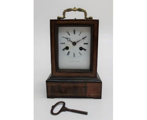 A 19th century French rosewood mantle clock, the stepped rectangular case with florally cast bail handle enclosing an eight d