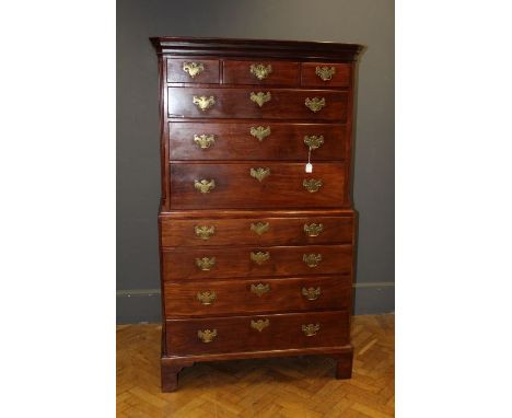 A George III walnut chest on chest, the moulded cornice over three short and three long drawers and three long drawers below,