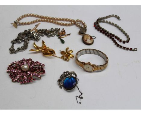 A selection of mid 20th century jewellery comprising a yellow metal coated orchid brooch and pendant, a yellow metal butterfl