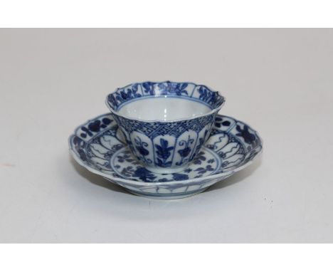 A Chinese blue and white tea bowl and saucer, Kangxi, decorated with reserved bands of floral forms. Saucer diameter 11cm