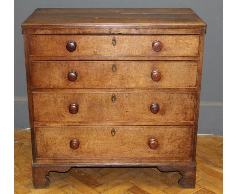 A George III oak chest of drawers having two short and three long drawers with knob handles, raised on bracket feet, width 93