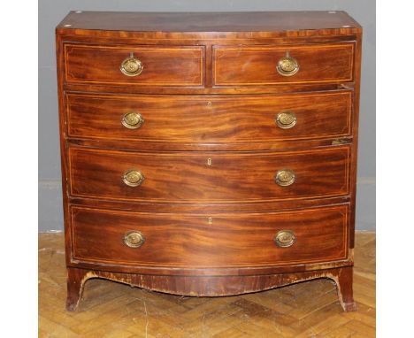 An early 19th century mahogany chest of bow front form, the ebony and satinwood strung top over two short and three graduated