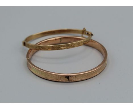 A pair of engraved bangles,, one hallmarked hinge bangle with safety chain, approximate weight 12.3gm, the second a 9ct stamp