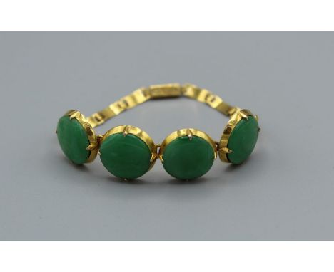 An antique Apple Jade (Jadeite) bracelet in yellow metal. The jade comprises four cabochons of a diameter of approximately 14