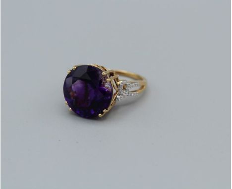 An 18k Gemporia amethyst and diamond ring, the round amethyst of 11.35ct, with diamond set pierced shoulders, total diamond w