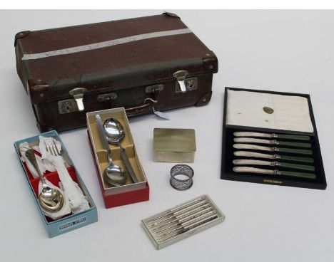 A small early 20th century suitcase containing stainless steel and EPNS cutlery in boxes, an EPNS cigarette box, a white meta