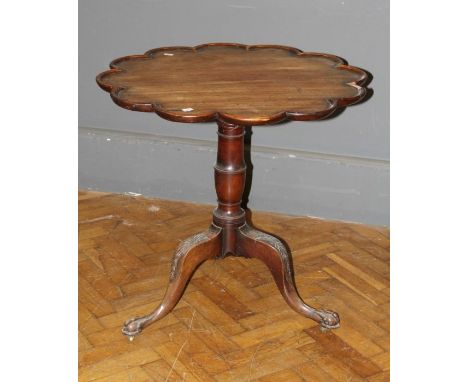 A 19th century, George II style tripod table, the scallop moulded snap top on a ring turned baluster column, foliate carved d