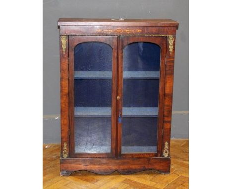 A Victorian walnut veneered dwarf cabinet enclosed by a pair of glazed panel doors