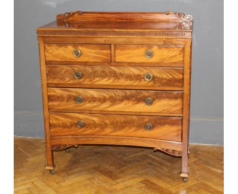 An Edwardian mahogany chest, the oblong top over two short drawers with brass ring handles, raised on square section legs, w1