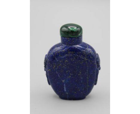 Chinese snuff bottle.Lapis lazuli of shield shape on a raised foot, with tao tie mask and ring handles at the shoulders, the 