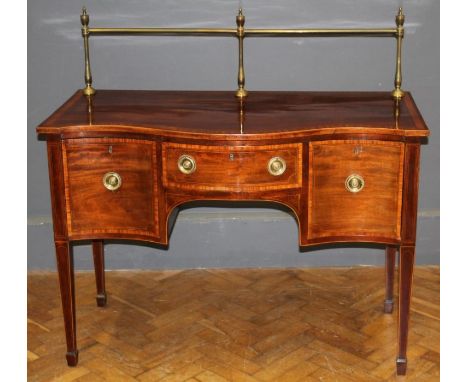A mid 19th century mahogany serpentine fronted sideboard of small proportions with brass rail, the satinwood crossbanded top 