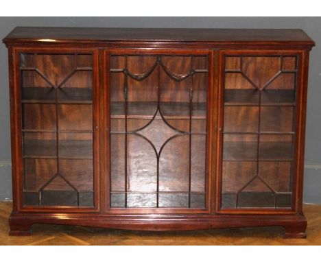 An Edwardian mahogany, satinwood banded dwarf bookcase, the rectangular top over swag barred glazed door flanked by astragal 