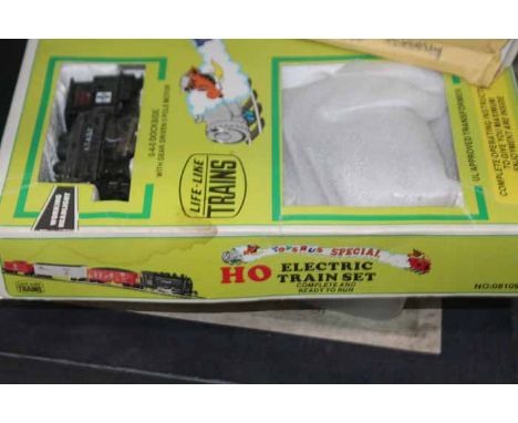 LOT OF MODEL TRAIN ENGINES AND ACCESSORIESincluding several carriages and frieght cars, many sections of tracks etc.