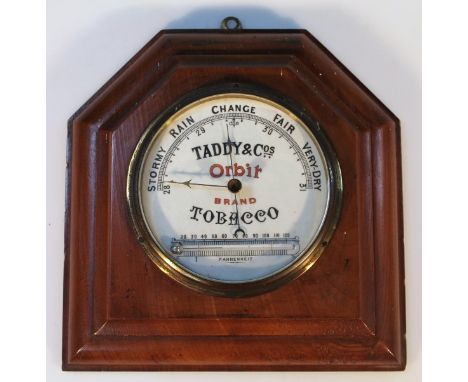 A Taddy & Co Orbit tobacco advertising wall barometer, of shaped moulded form, centred by a circular metal and glass section,