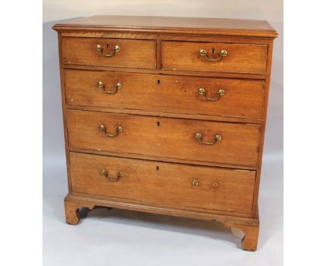 An early 19thC oak chest, the plain moulded cross banded top raised above two short and three long drawers, each with swan ne