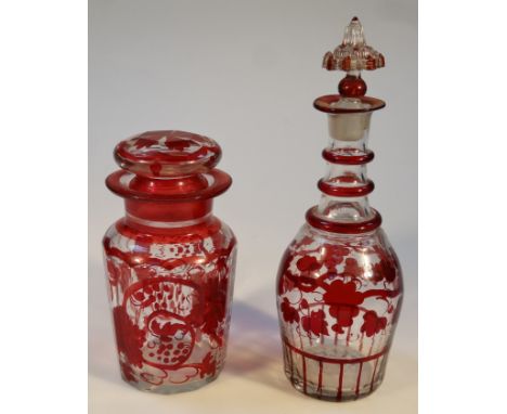 A ruby flash glass decanter, with shaped stopper of cylindrical shouldered form decorated with flowers and a similar jar and 