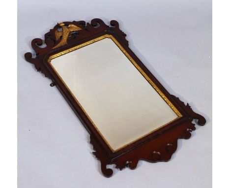 A 19thC mahogany fret mirror, the pierced frame centred with a gilded ho-ho bird, above a shaped glass with a gilt moulded su