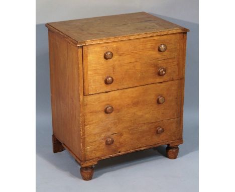 A 19thC commode chest, of rectangular form, the moulded top raised above two articulated and two fixed drawers on bun feet wi
